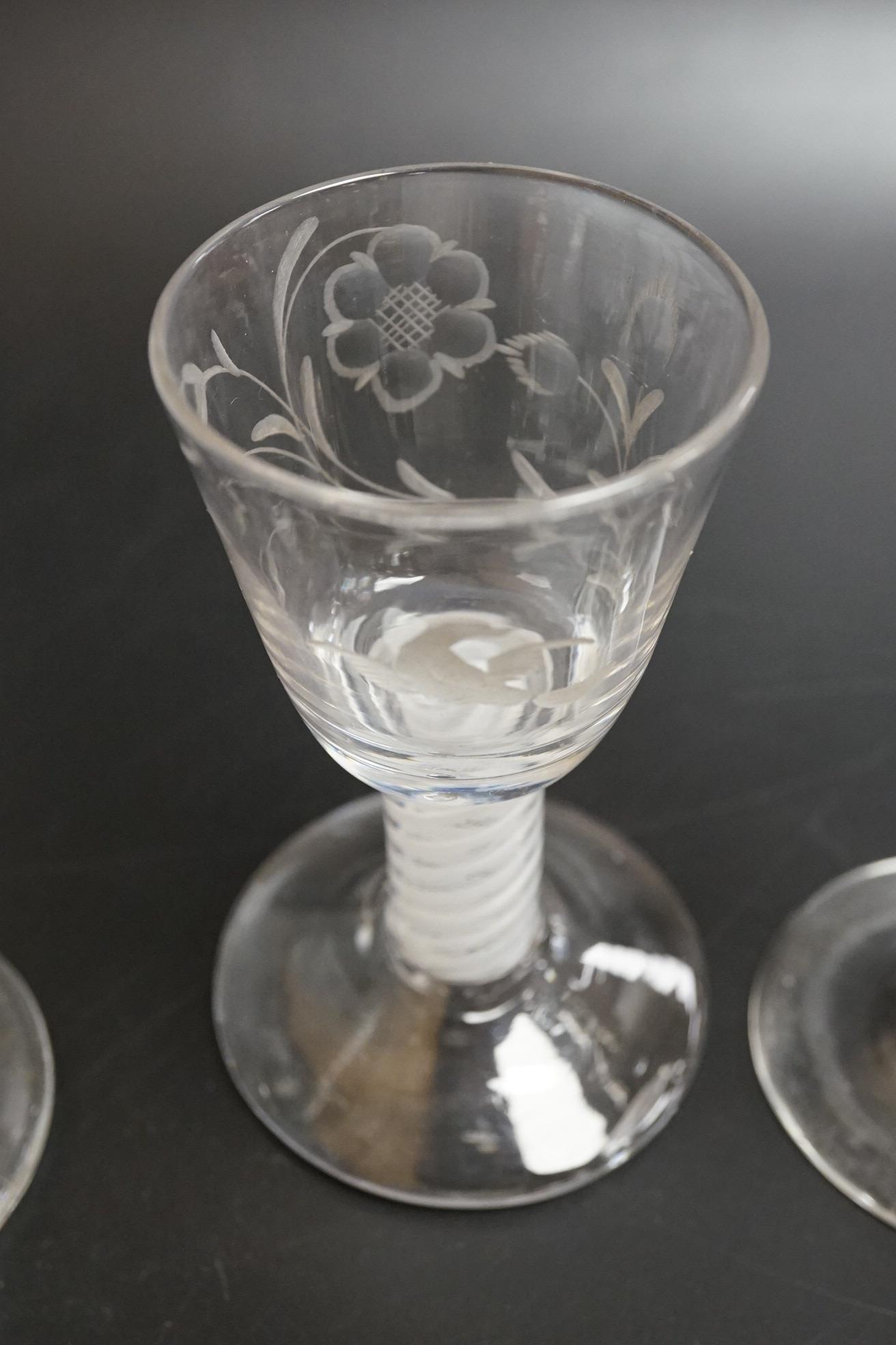 Two George III firing glasses, one with DSOT stem, together with a gin glass with engraved bowl, tallest 11.5cm high (3)